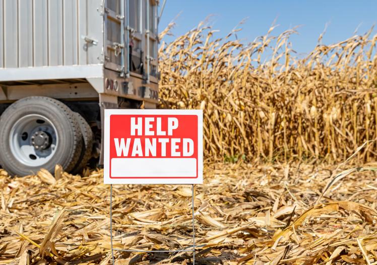 Help wanted sign in farm field
