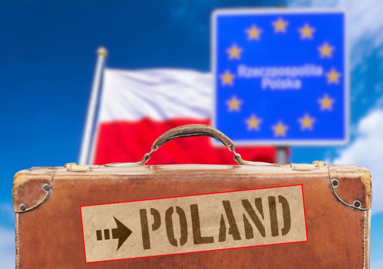 Polish flag, a suitcase and destination Poland 