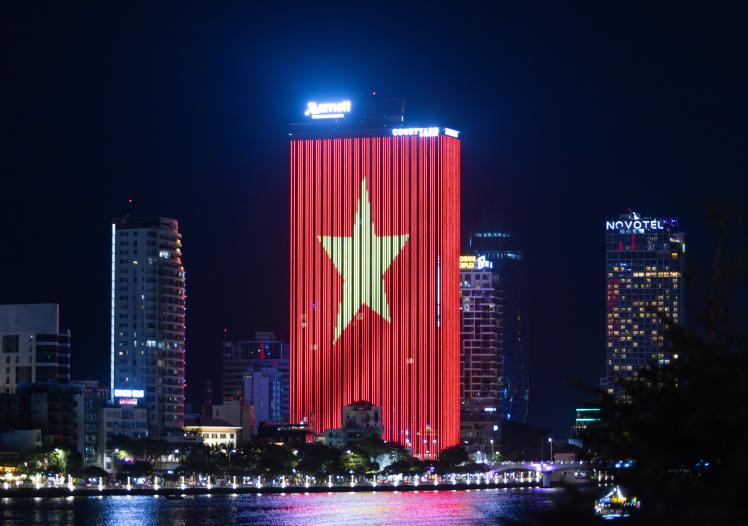 Vietnamese flag led wall is bright in one of building in Danang