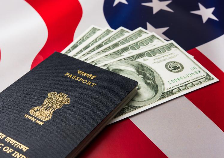 Indian passport with US currency notes 