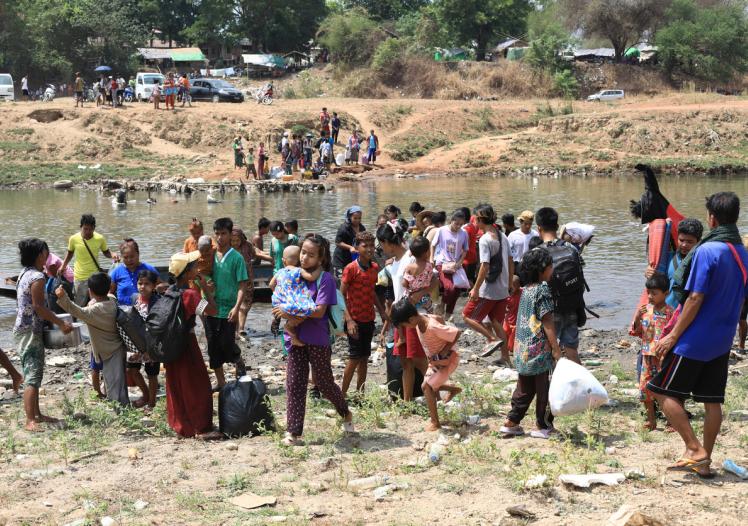Refugees from Myanmar crossing the border into Thailand
