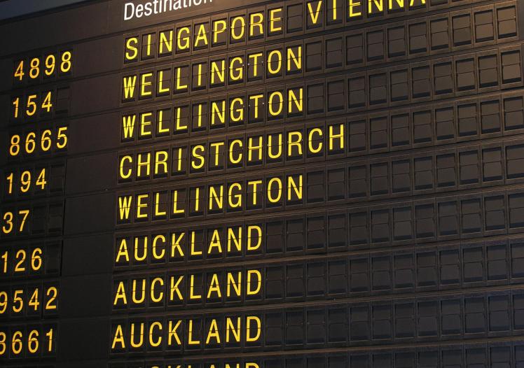 A analog departures board at an airport