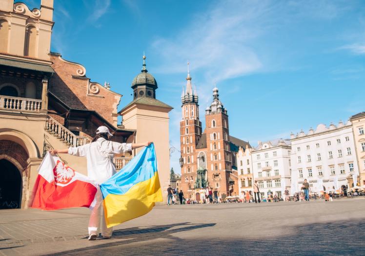 Woman with ukrainian and poland flag at Krakow