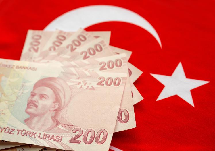Close-up of Turkish Lira on Turkish Flag.