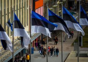 Estonian flags on the background of a pedestrian street in Tallinn