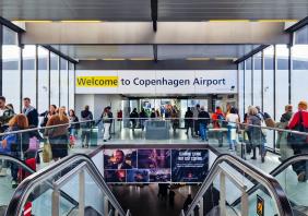 People walking inside Copenhagen airport.