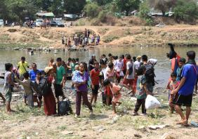 Refugees from Myanmar crossing the border into Thailand
