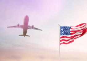 USA Flag With Airplane At Background 