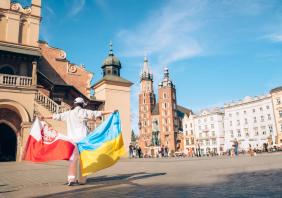 Woman with ukrainian and poland flag at Krakow