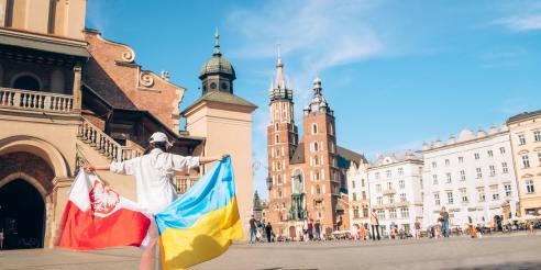 Woman with ukrainian and poland flag at Krakow