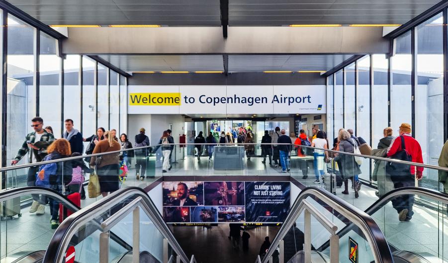 People walking inside Copenhagen airport.