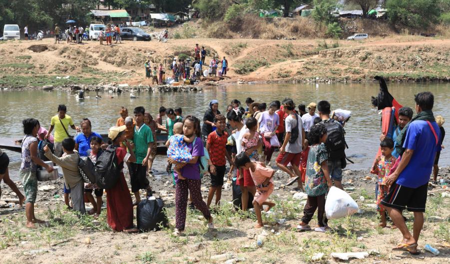 Refugees from Myanmar crossing the border into Thailand