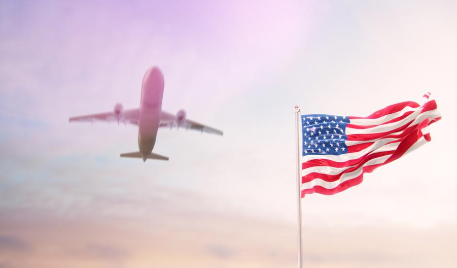 USA Flag With Airplane At Background 