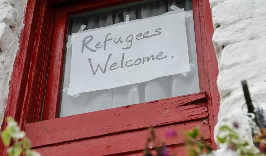 Sign on a window saying "Refugees Welcome"