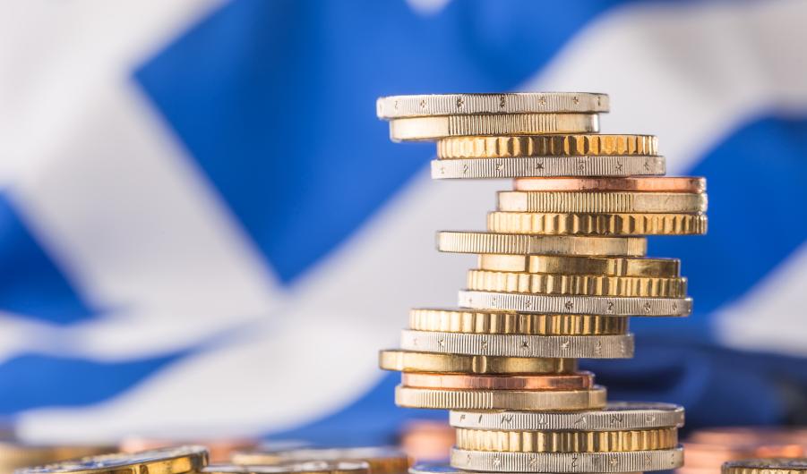 National flag of greece and euro coins