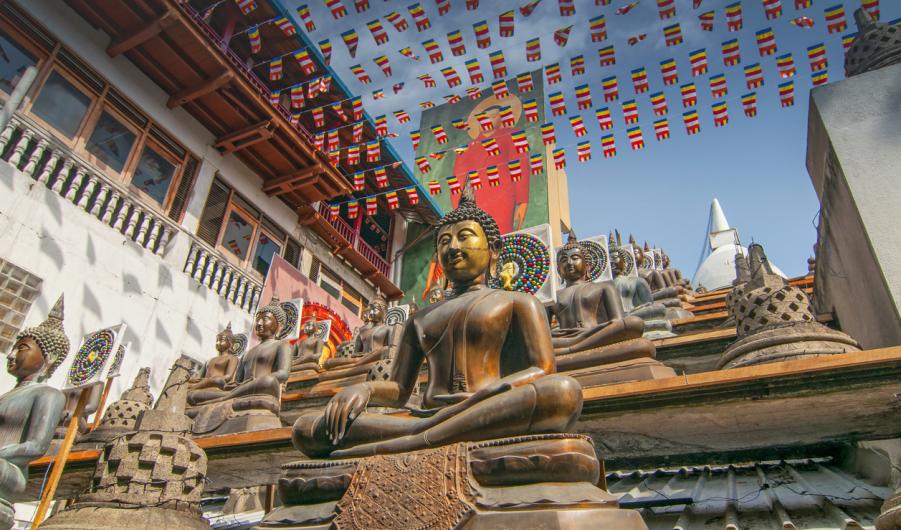 Statues of the Buddha in the lotus position, Gangaramaya Buddhist Temple, Colombo, Sri Lanka