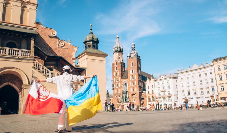 Woman with ukrainian and poland flag at Krakow
