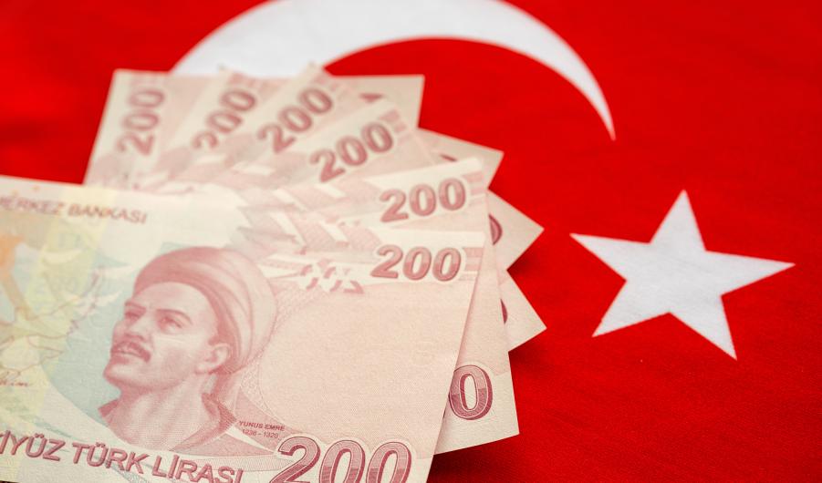 Close-up of Turkish Lira on Turkish Flag.